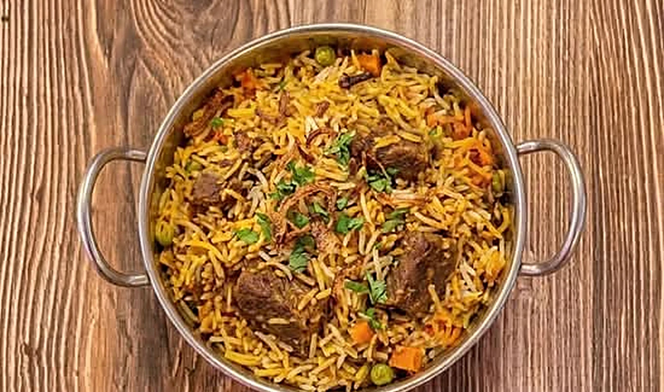 Tandoori chicken biryani at Saffron Canmore - dum biryani layered with smoky tandoor-grilled chicken